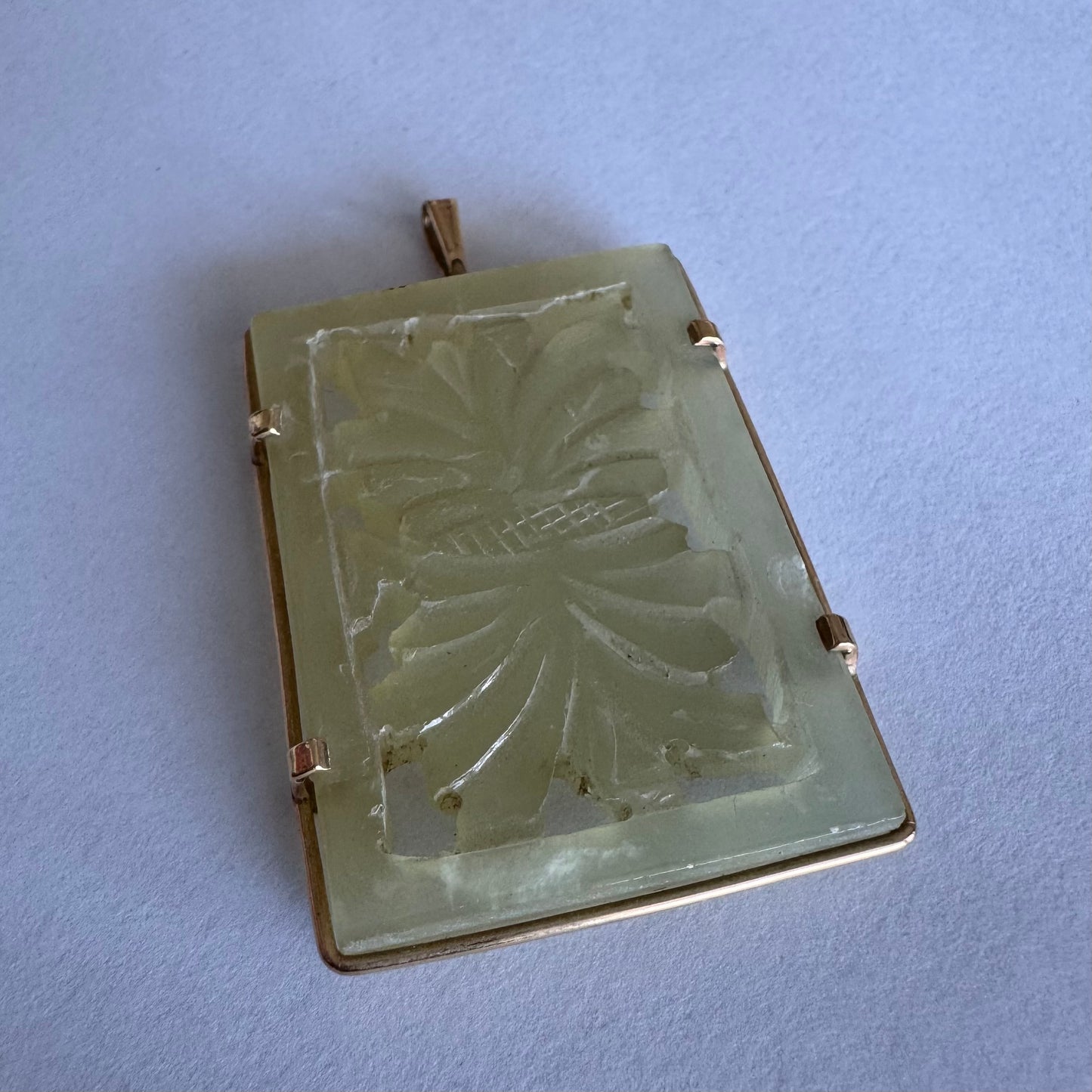 14K gold rectangular pendant set with a hand-carved milky Jade stone