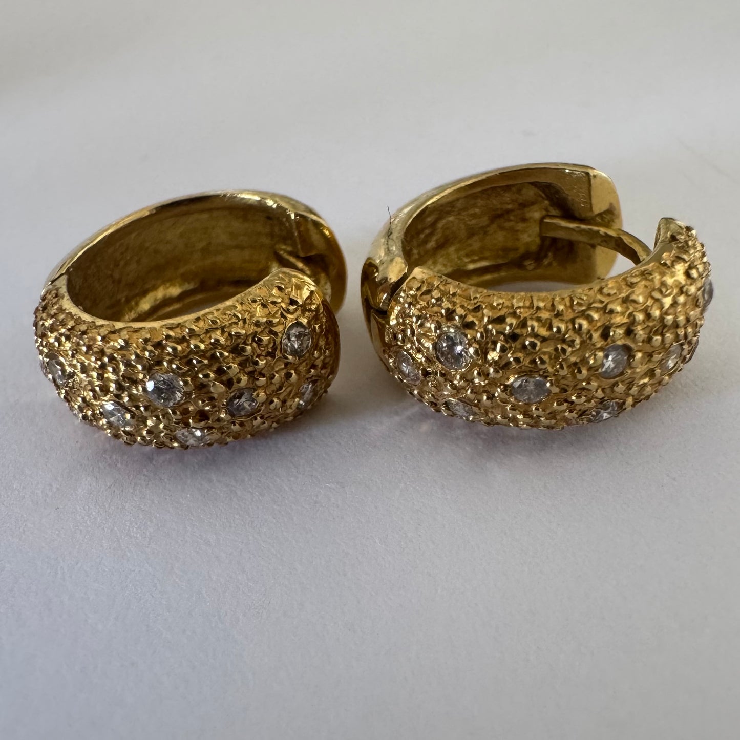 18K gold hoop earrings designed with a rich organic texture and set with Diamonds