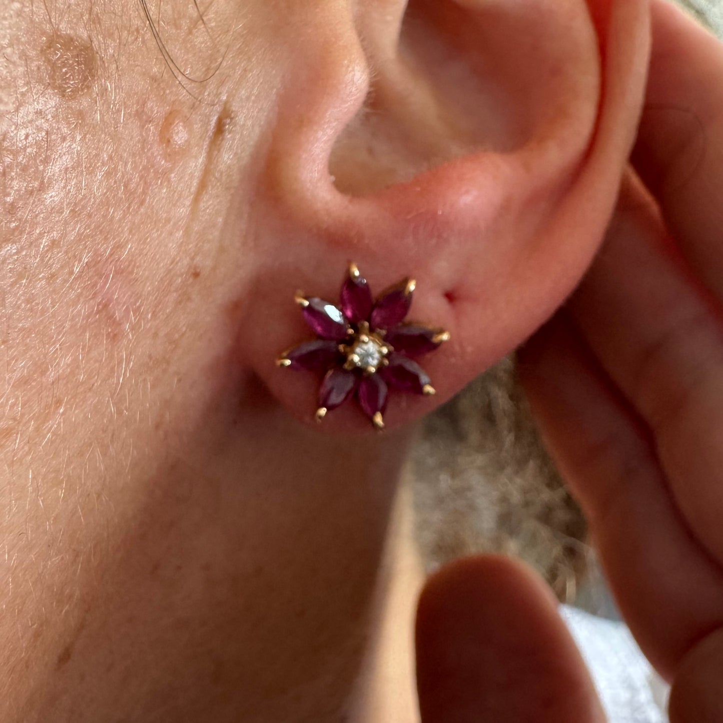 14K gold floral earrings set with marquise-cut Rubies and a small Diamond at the center