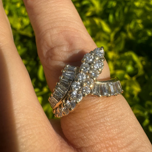 14K gold ring set with a striking combination of round brilliant and baguette-cut Diamonds