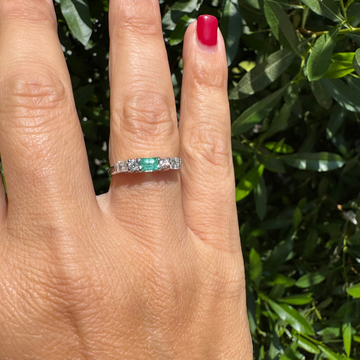 14K gold ring set with one center Emerald & Diamonds on the sides