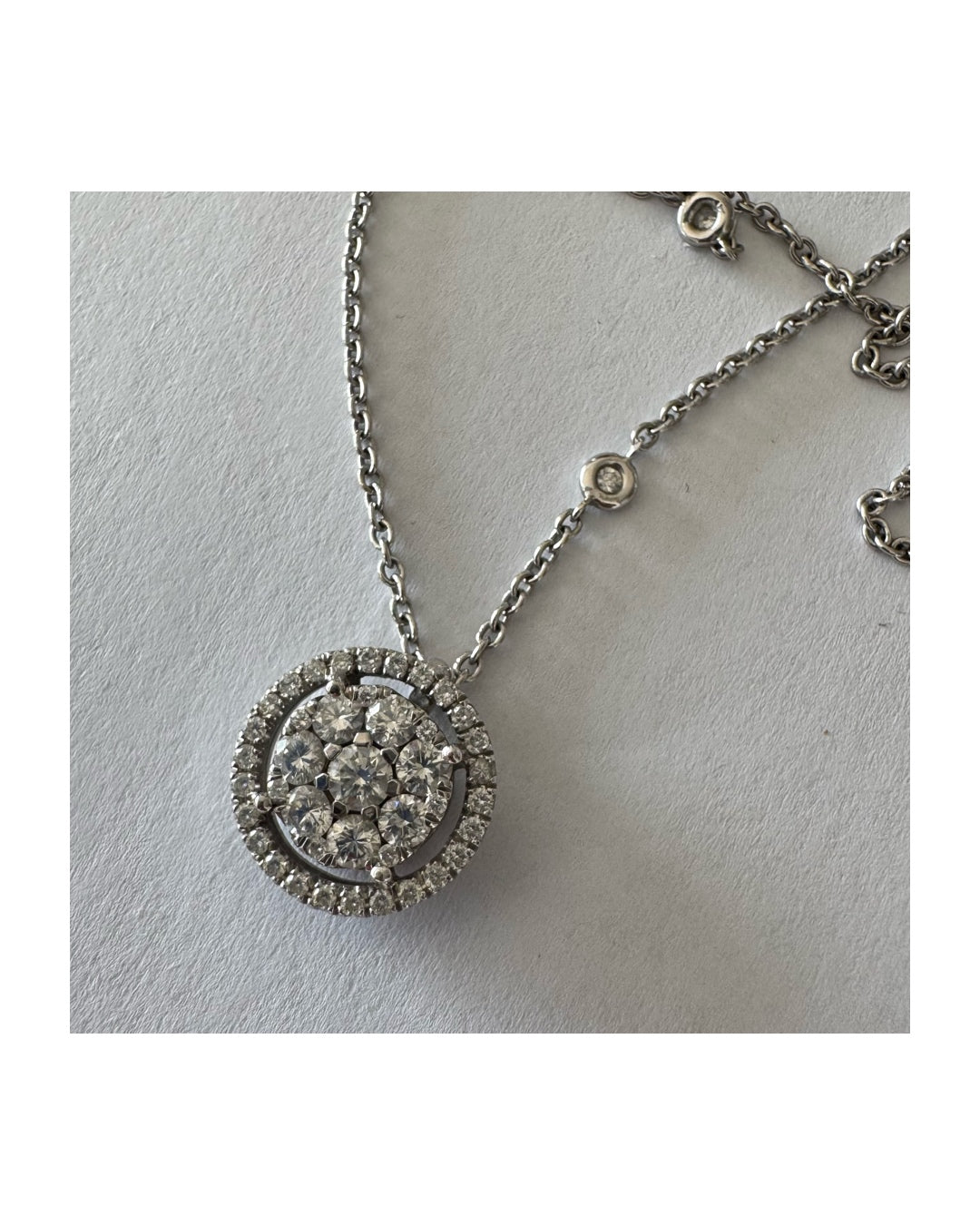 14K gold necklace featuring a round pendant set with a cluster of sparkling Diamonds