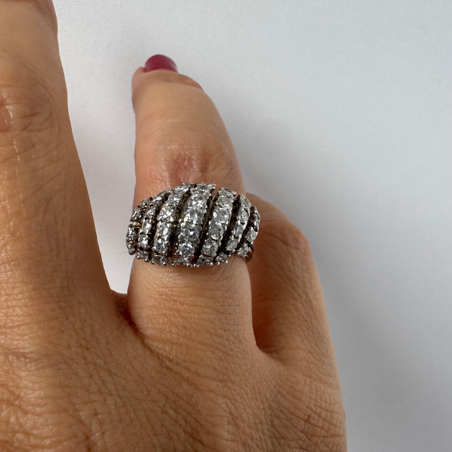 18K gold diamond ring with curved rows of brilliant stones.