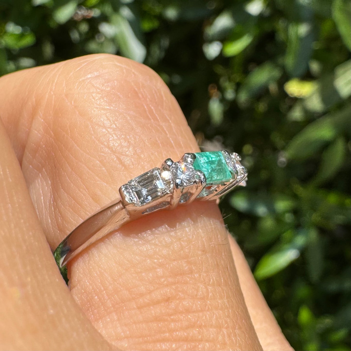 14K gold ring set with one center Emerald & Diamonds on the sides