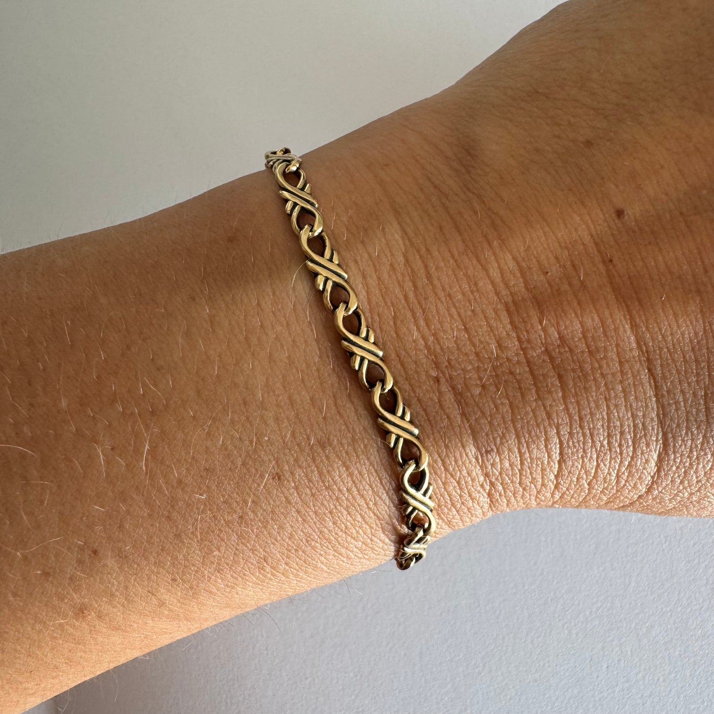 14K gold bracelet with a delicate twisted-link design.