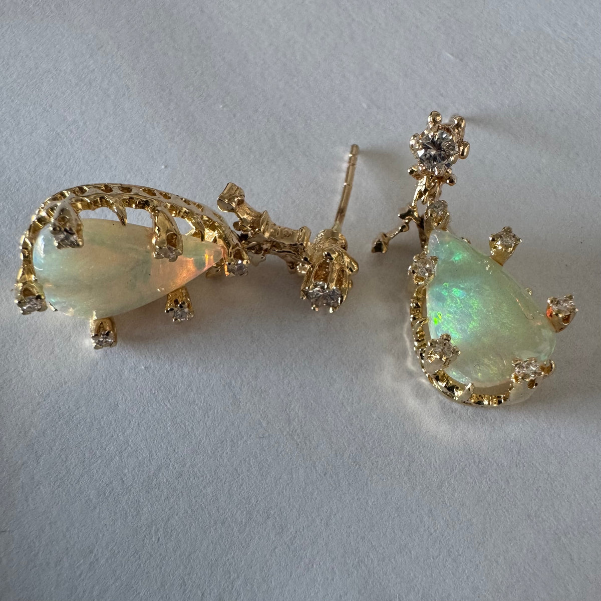 14K gold drop earrings set with pear-shaped Opals and Diamonds.