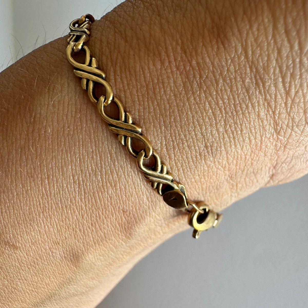 14K gold bracelet with a delicate twisted-link design.