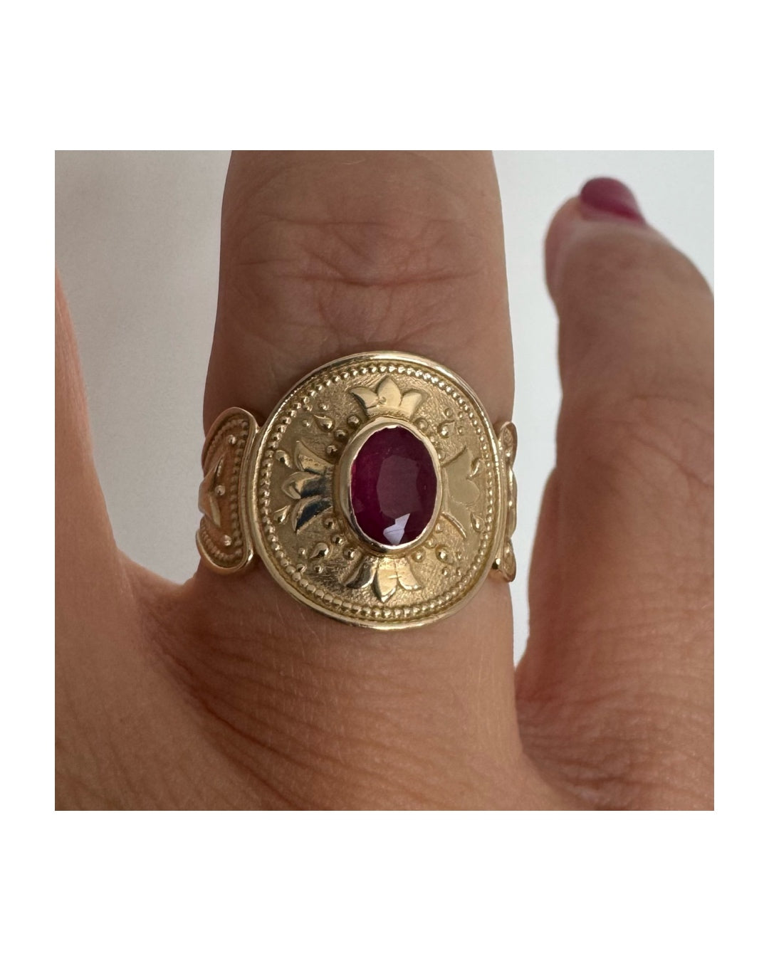 14K gold ring set with an oval Ruby
