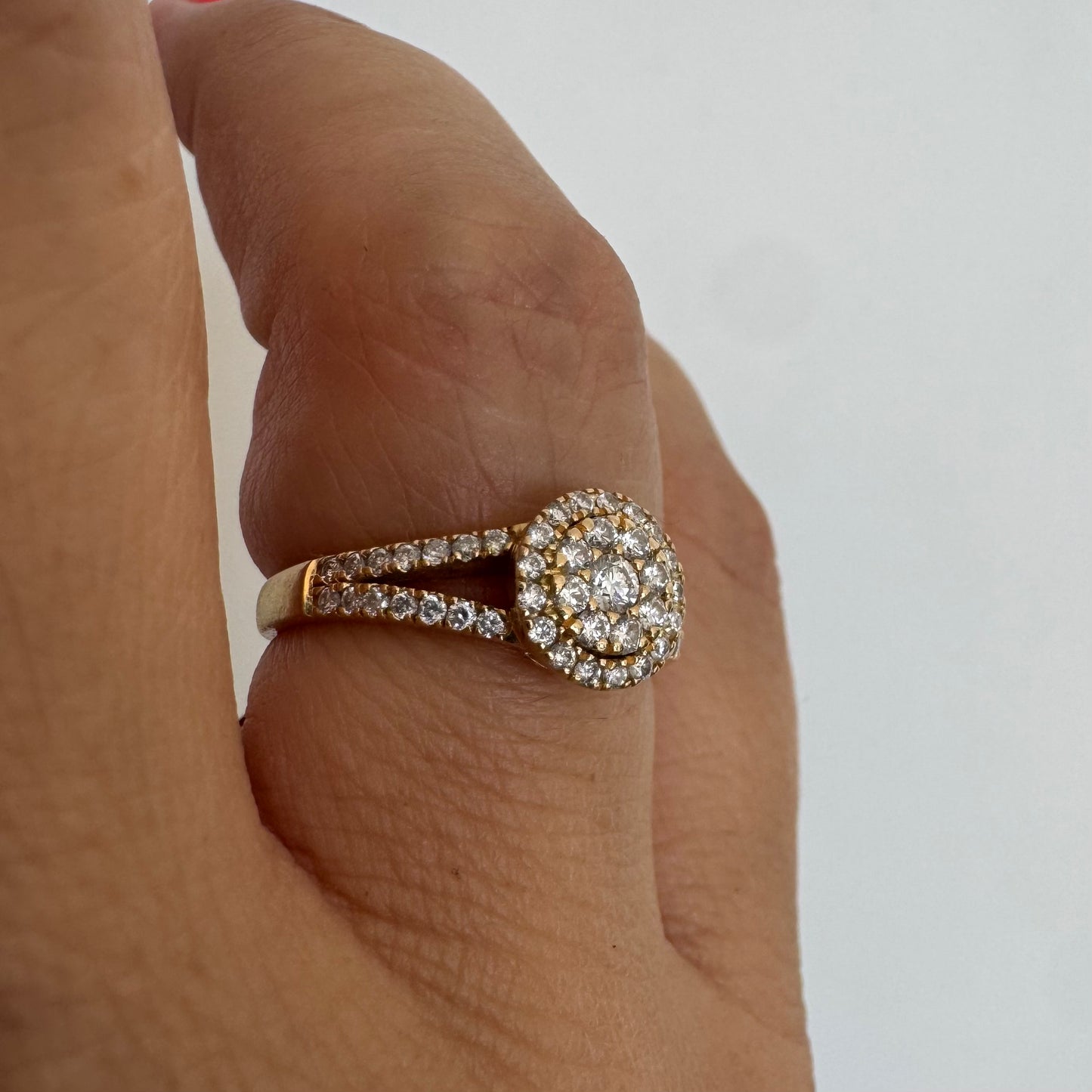 14K gold ring set with Diamonds in a sparkling halo design.