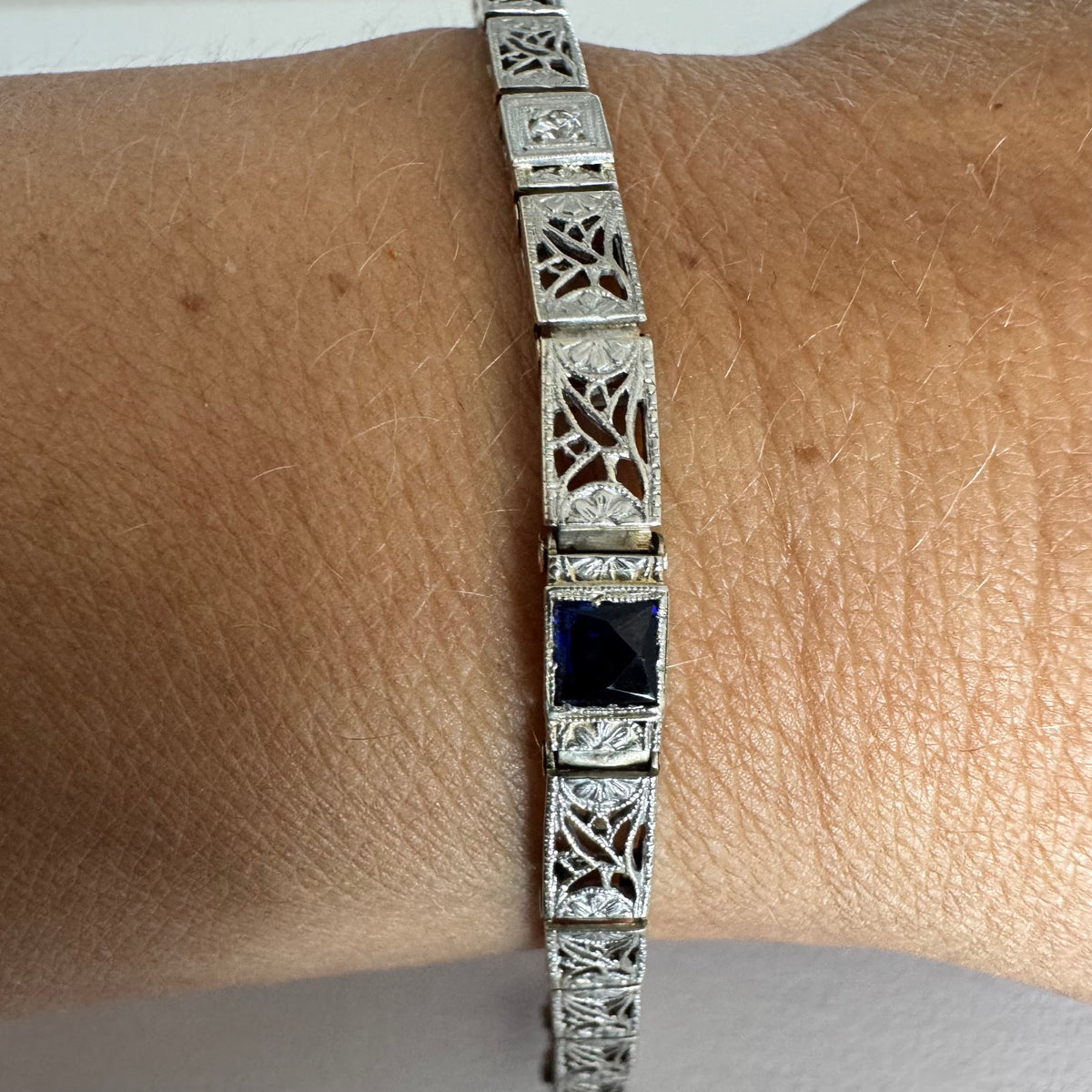 14K gold bracelet featuring intricate openwork and beautifully engraved details set with Sapphire & Diamonds