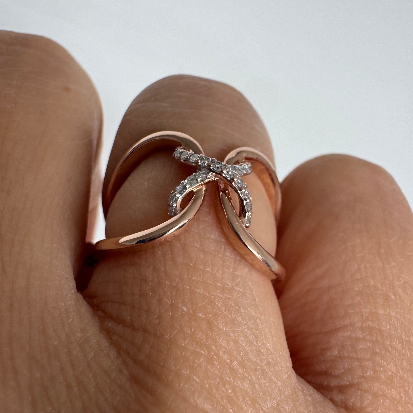 10K rose gold ring set with natural Diamonds in a flowing & artistic design.