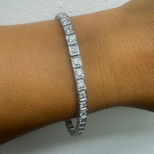 14K gold tennis bracelet set with sparkling round-cut Diamonds in square bezel settings, creating a timeless and sophisticated look.