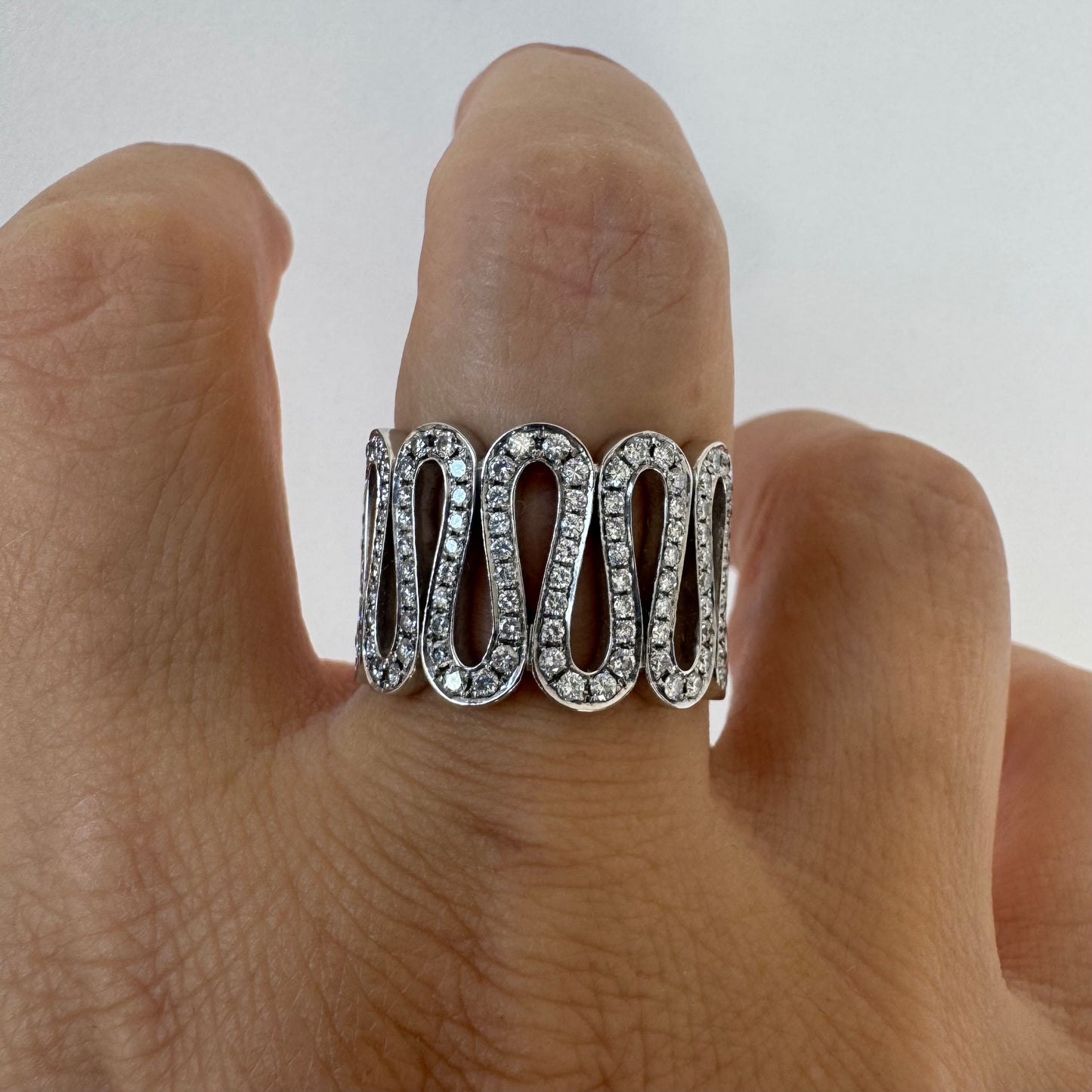 14K gold ring set with shimmering Diamonds in a flowing wave design