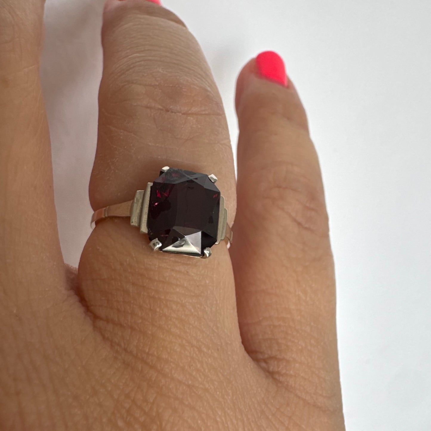 9K gold ring set with a deep burgundy Garnet in an elegant square cut.