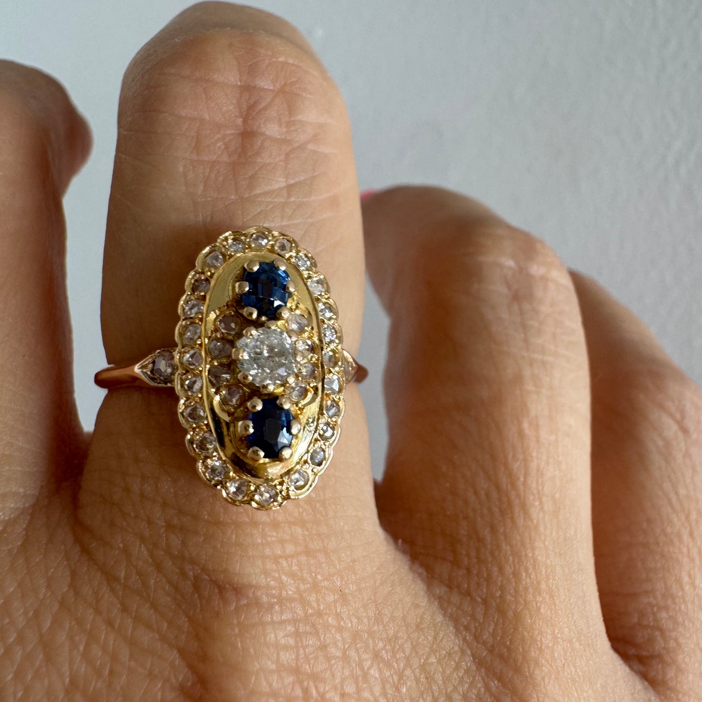 14K gold ring set with Diamonds and deep blue Sapphires in a classic oval design.