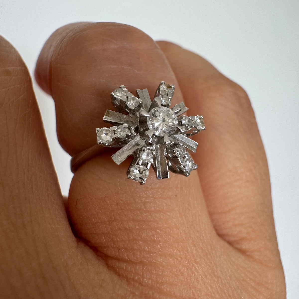 18K white gold ring designed as a radiant starburst, set with brilliant-cut diamonds that capture the light from every direction