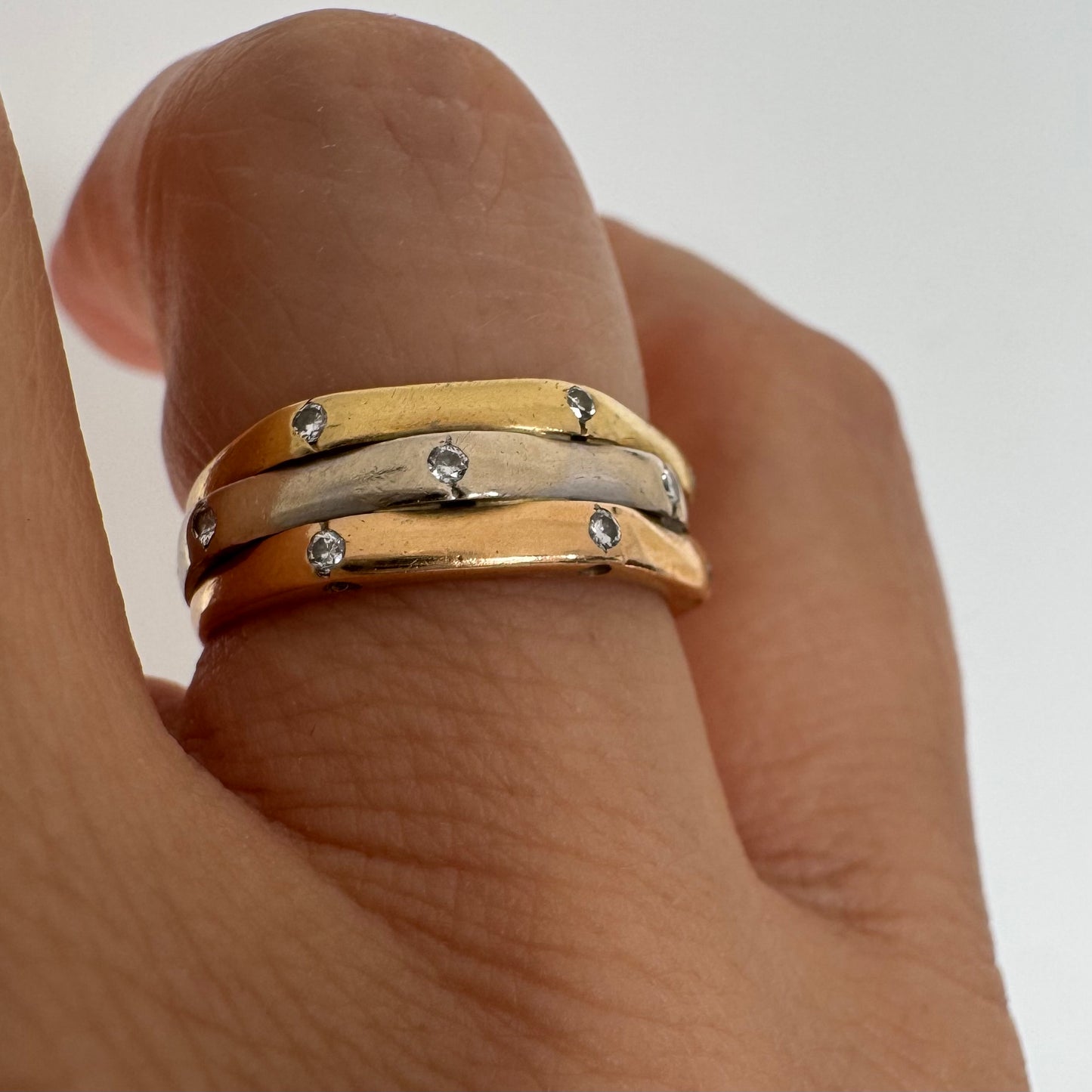 18K gold ring crafted in yellow, white, and rose gold, featuring a triple-band design set with Diamonds