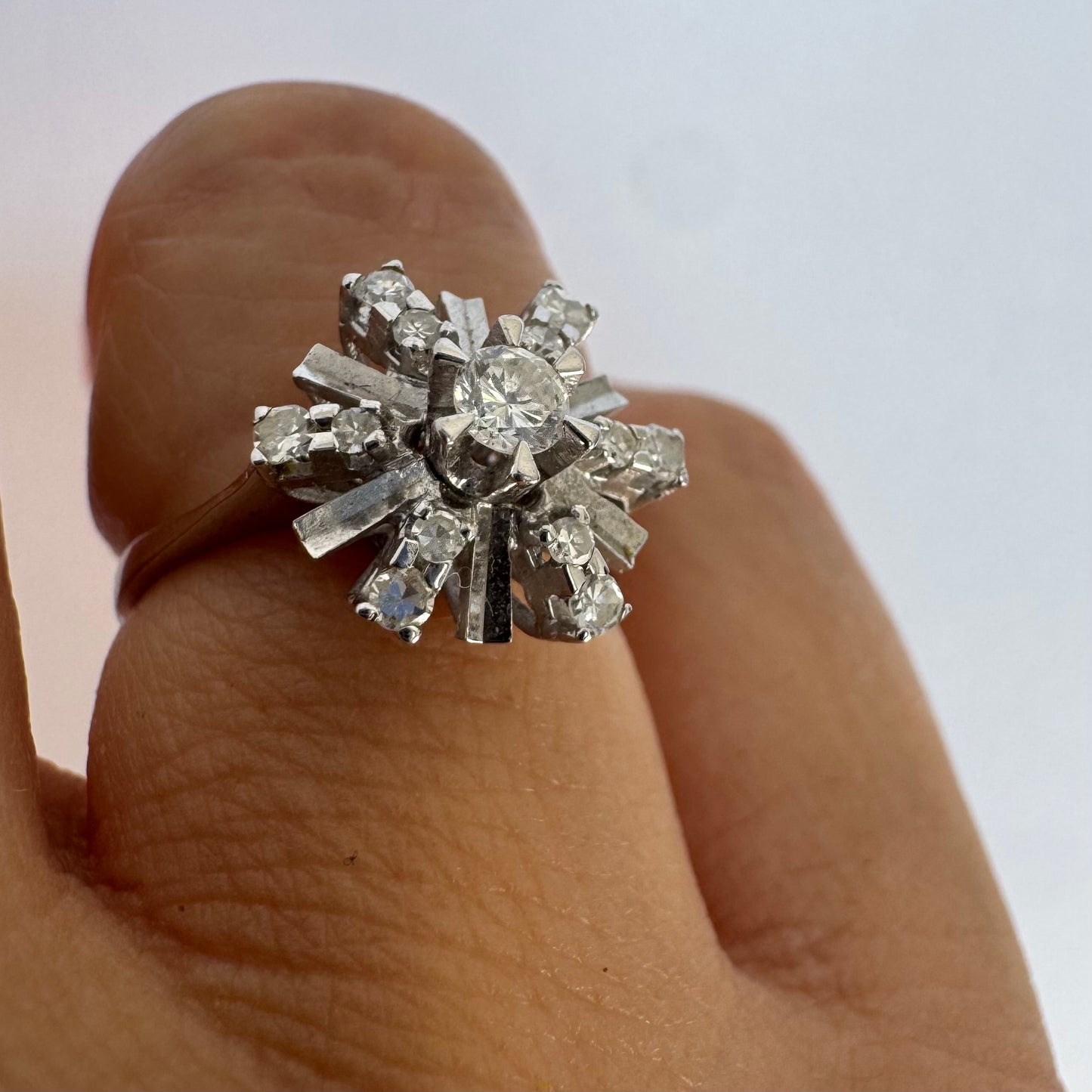 18K white gold ring designed as a radiant starburst, set with brilliant-cut diamonds that capture the light from every direction