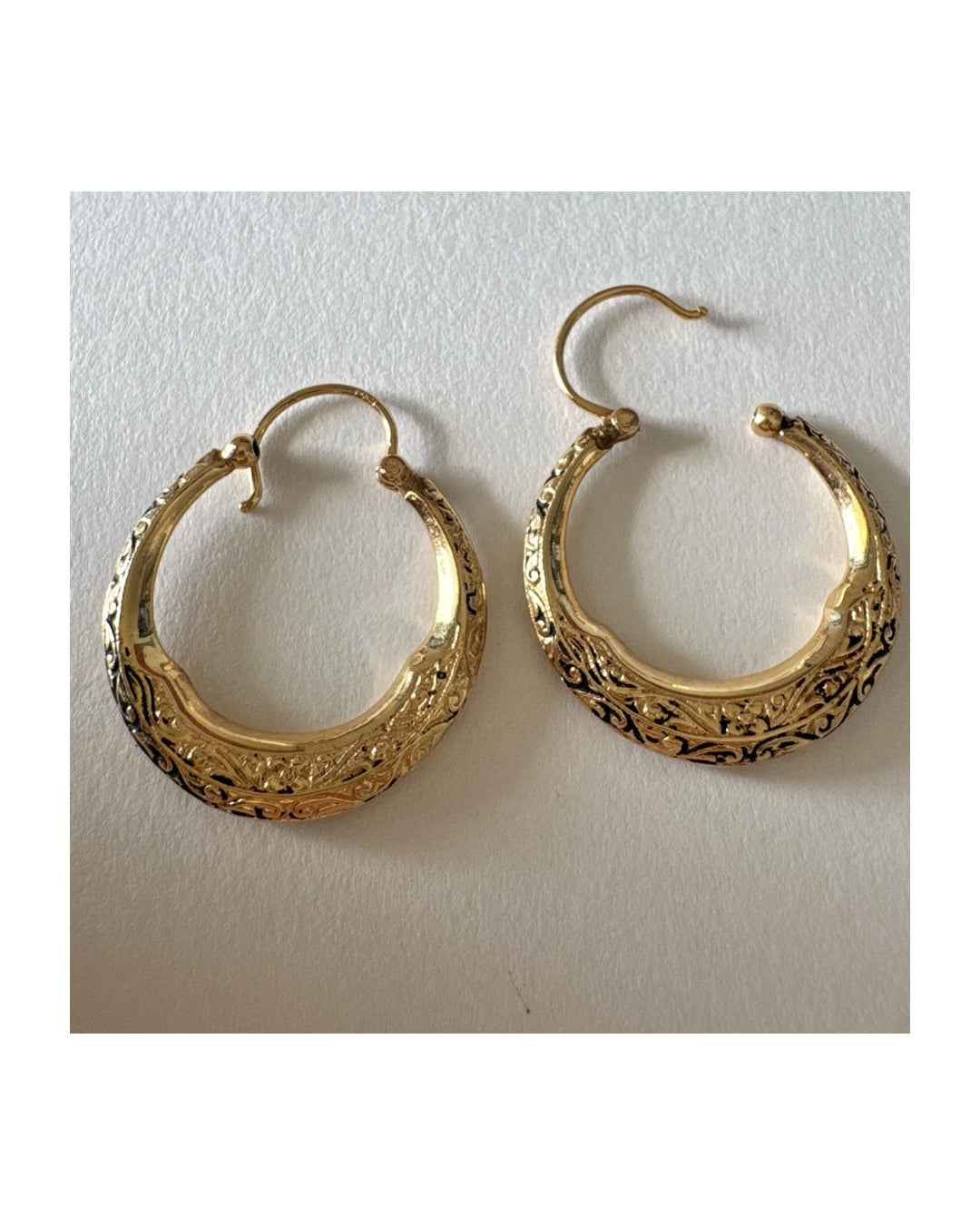 14K gold hoop earrings featuring an intricate openwork design and beautifully detailed engraving