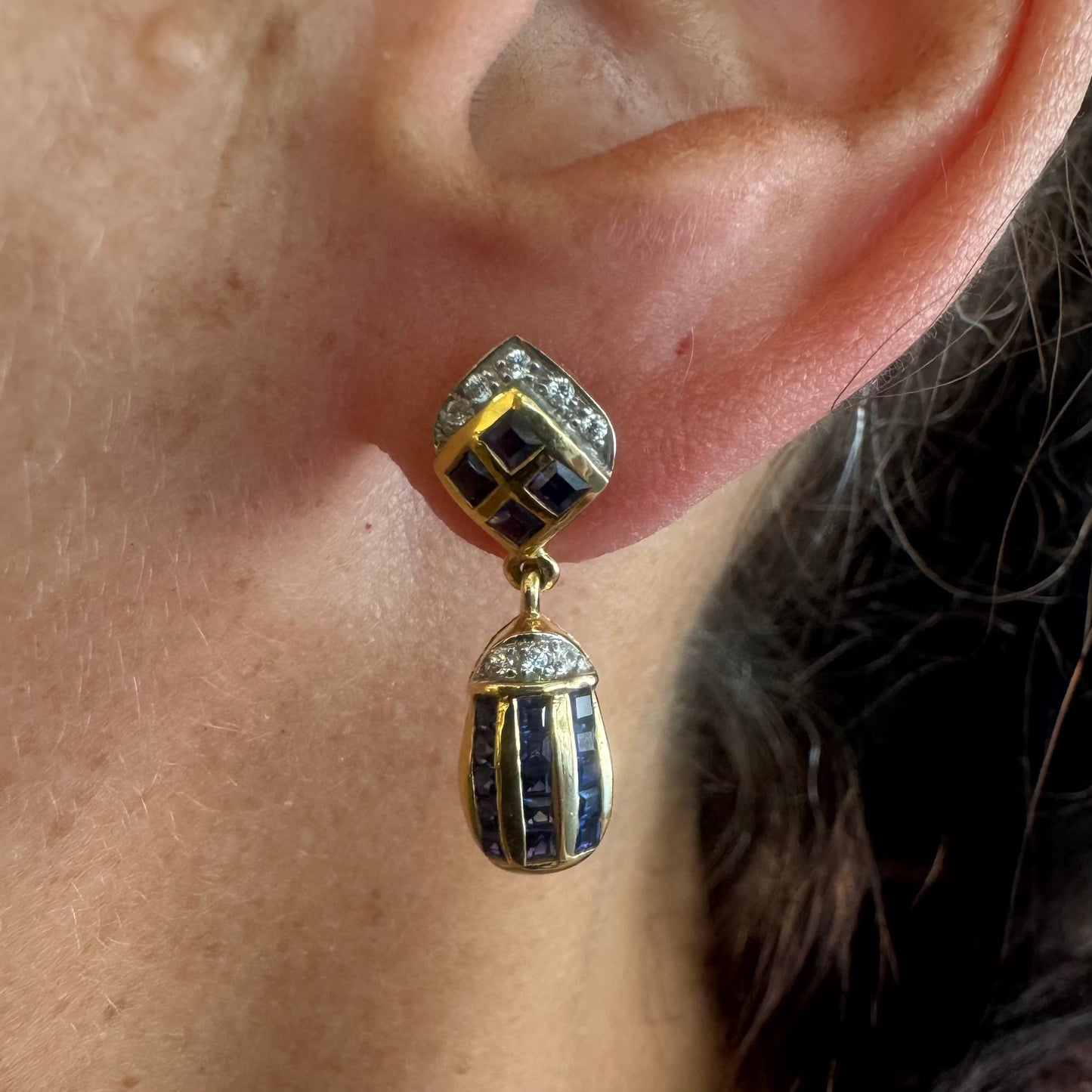 18K old drop earring set with deep blue Sapphires in a geometric pattern, accented with sparkling Diamonds.