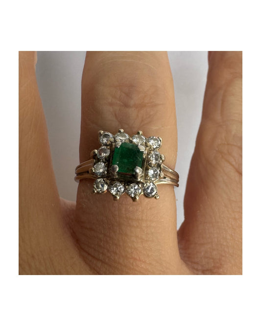 18K gold ring set with a vibrant square-cut Emerald surrounded by a sparkling halo of Diamonds.