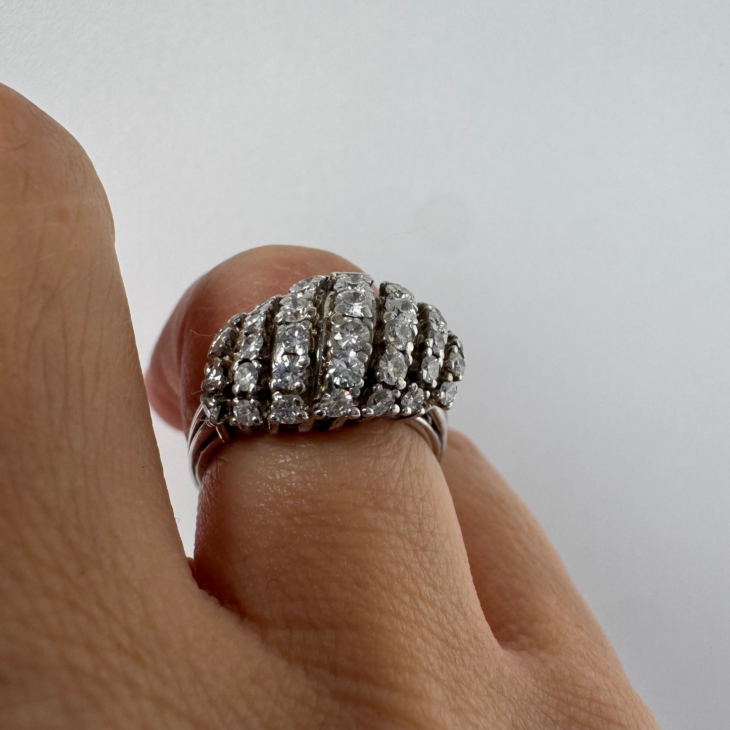 18K gold diamond ring with curved rows of brilliant stones.