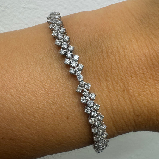 14K white gold bracelet set with sparkling white Diamonds in an elegant floral pattern.