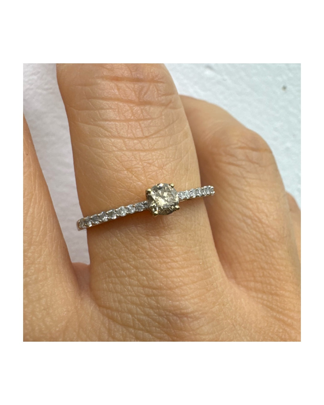 9K gold ring set with a central Diamond and sparkling Diamonds along the band