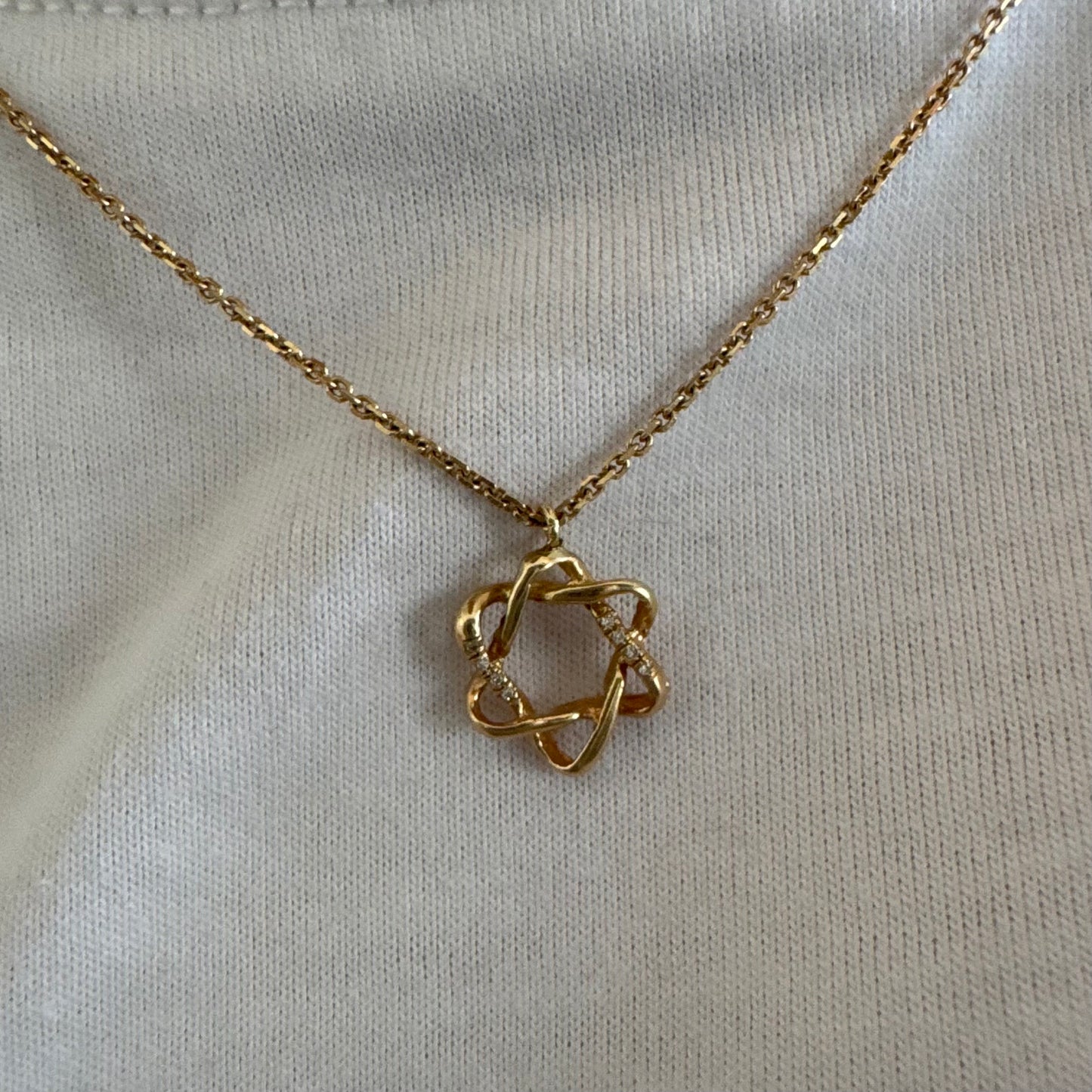 14K gold “Star of David” pendant with a sculptural open design.