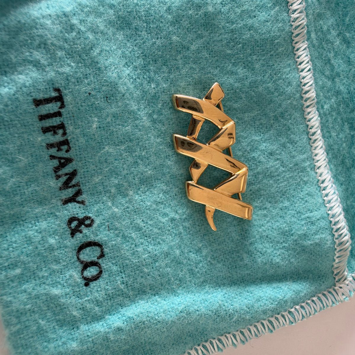 A Tiffany & Co. 18K gold brooch designed by Paloma Picasso from the iconic Graffiti Collection.