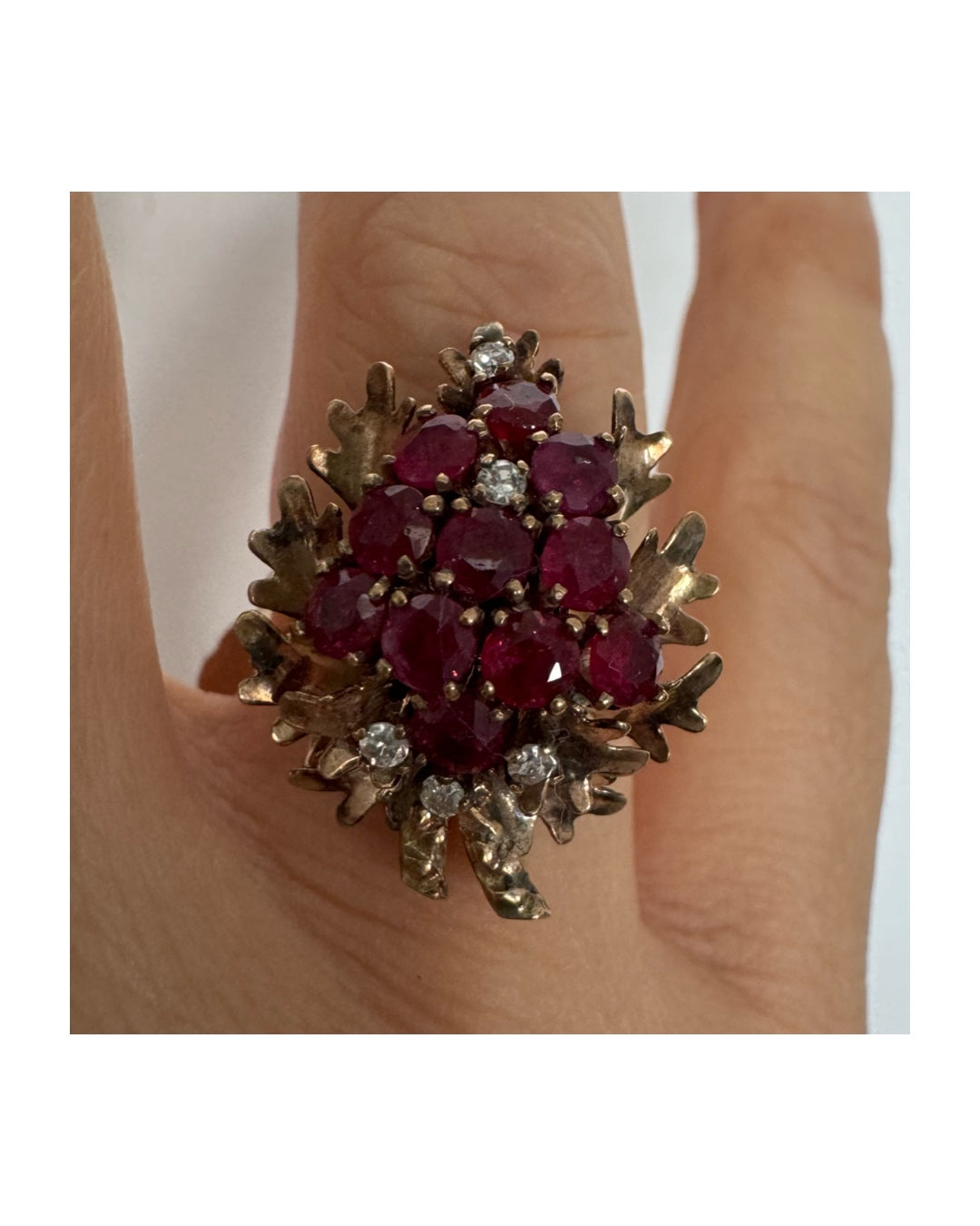 14K gold ring set with a vibrant cluster of deep red rubies and sparkling diamonds.