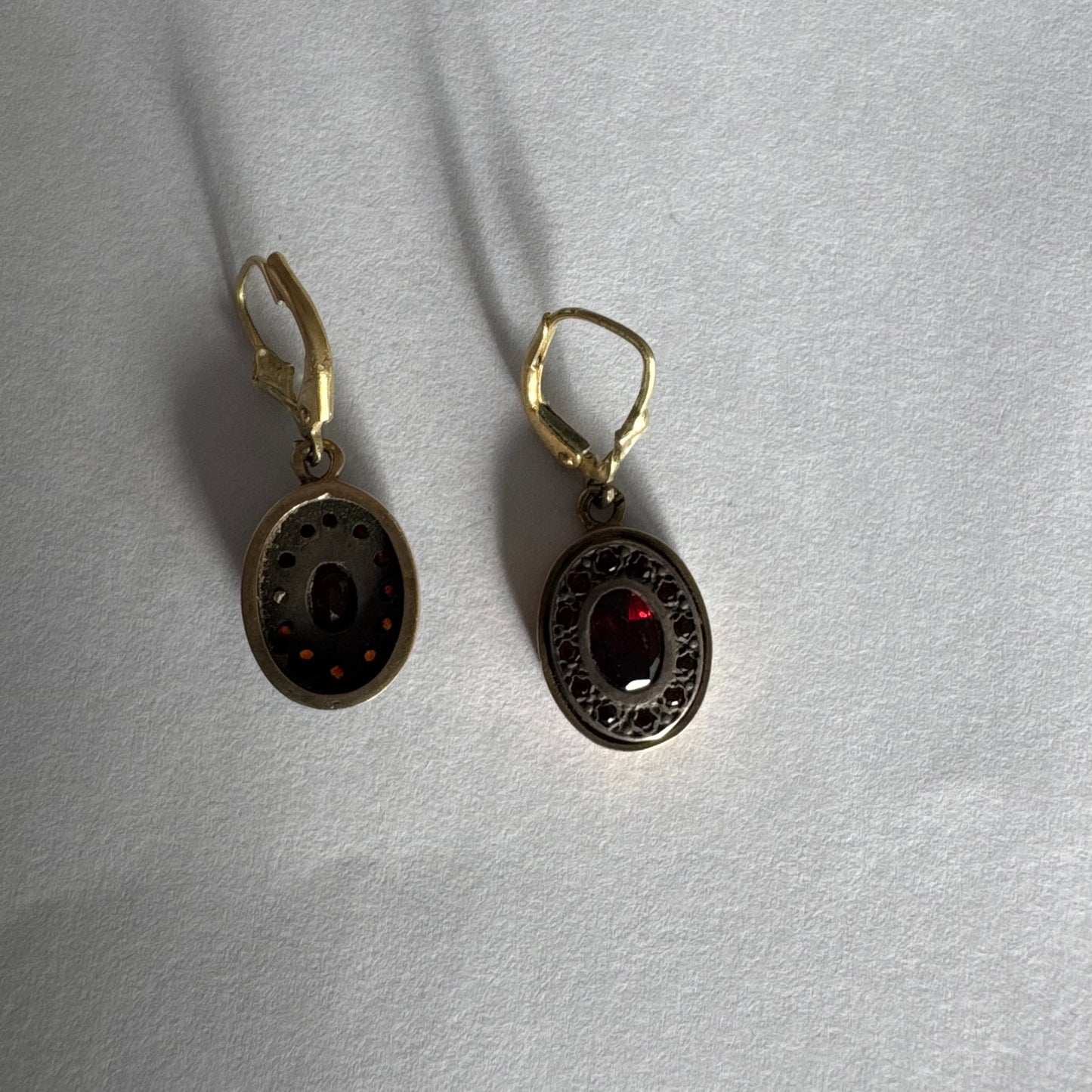 14K gold drop earrings set with deep red oval Garnets surrounded by smaller stones Garnets.