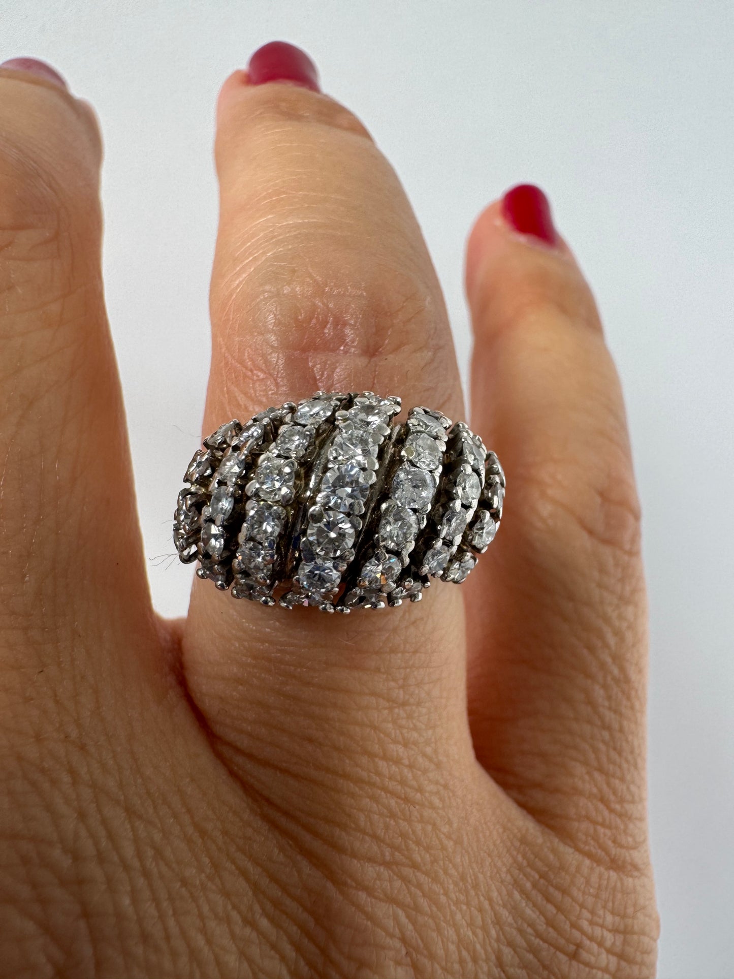 18K gold diamond ring with curved rows of brilliant stones.