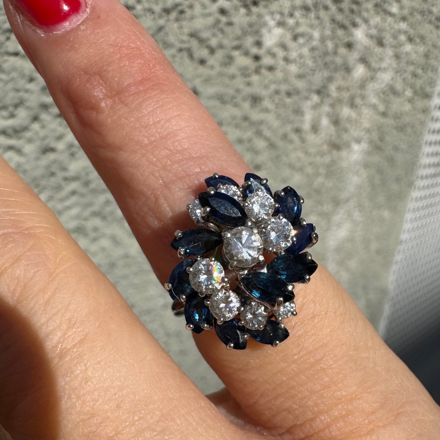 18K white gold ring, set with marquise-cut blue Sapphires and round Diamonds, in a classic cluster design.