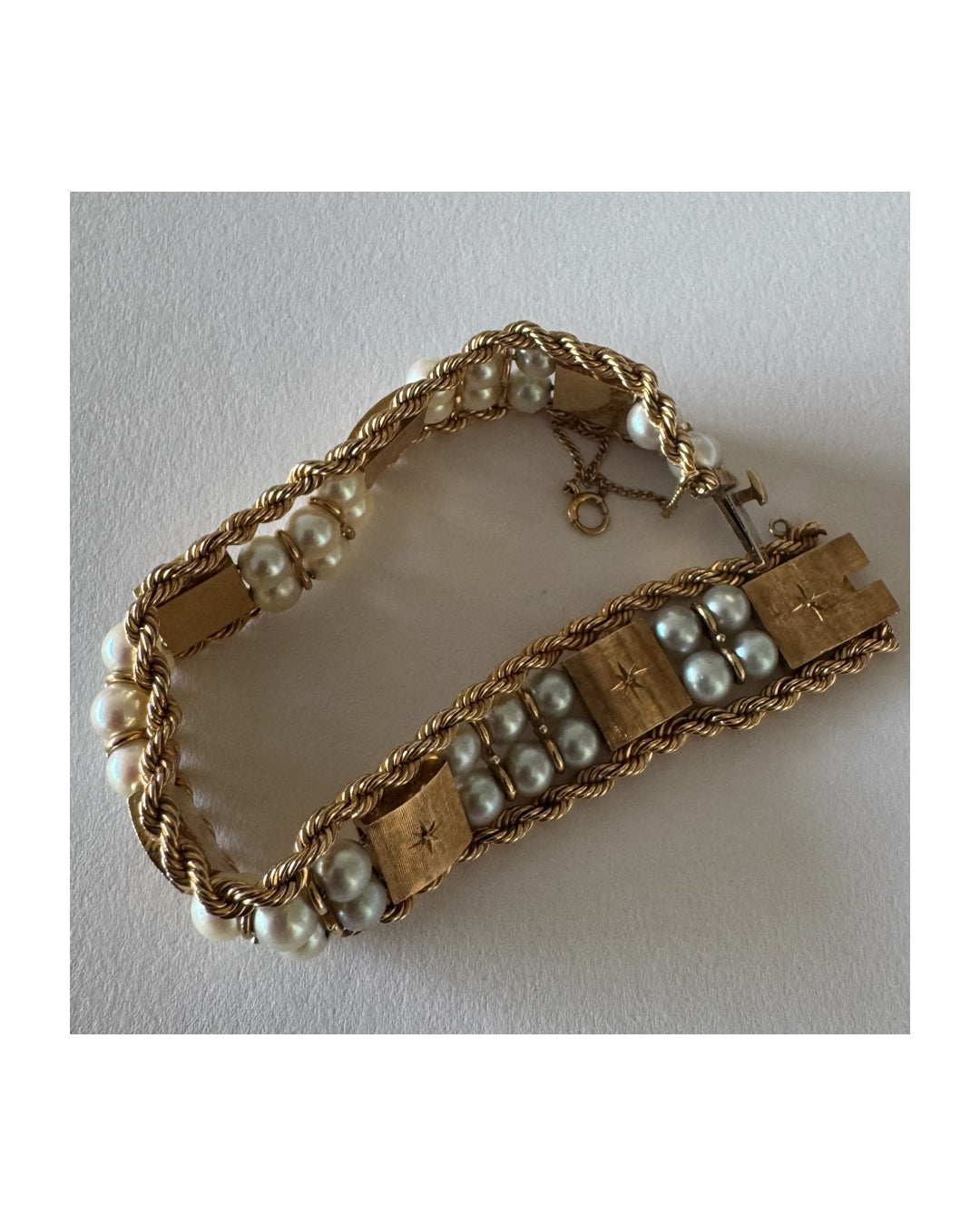 14K gold bracelet set with Pearls, featuring intricate rope-style detailing and textured geometric gold elements.