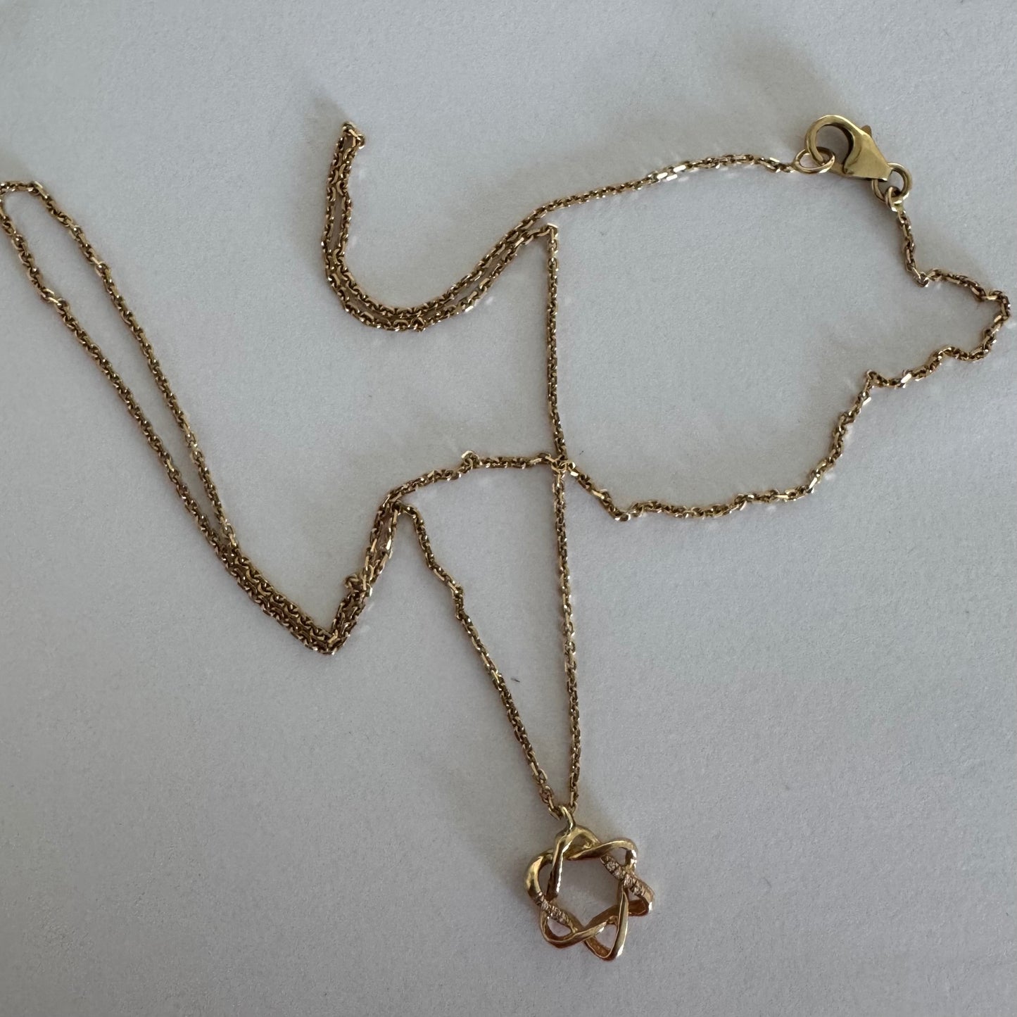 14K gold “Star of David” pendant with a sculptural open design.