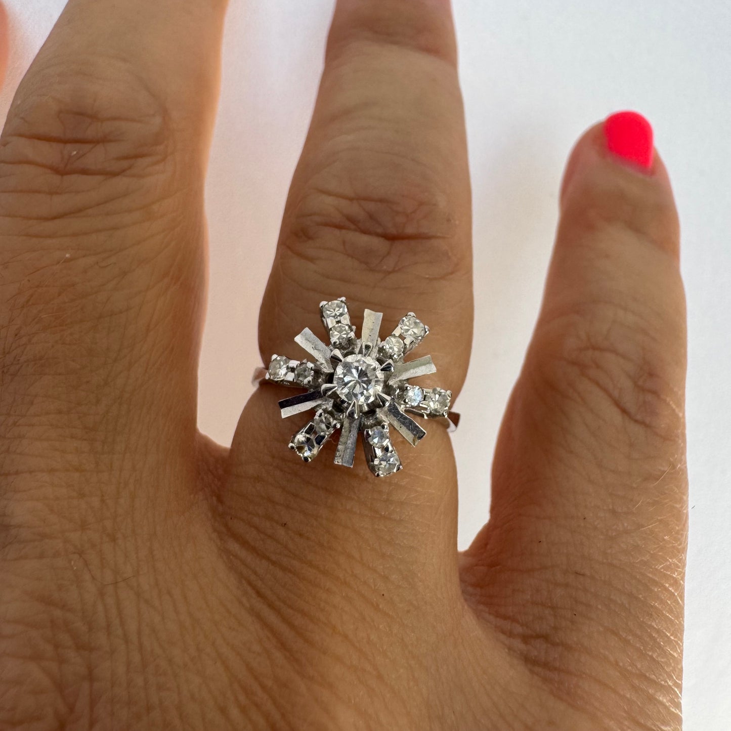 18K white gold ring designed as a radiant starburst, set with brilliant-cut diamonds that capture the light from every direction