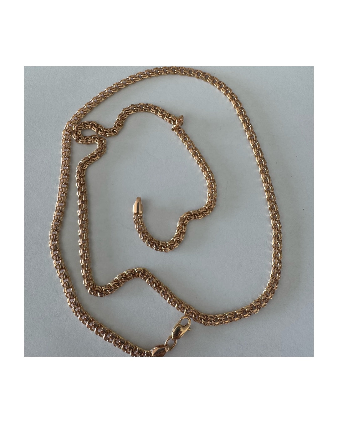 14K gold chain featuring an intricate woven link