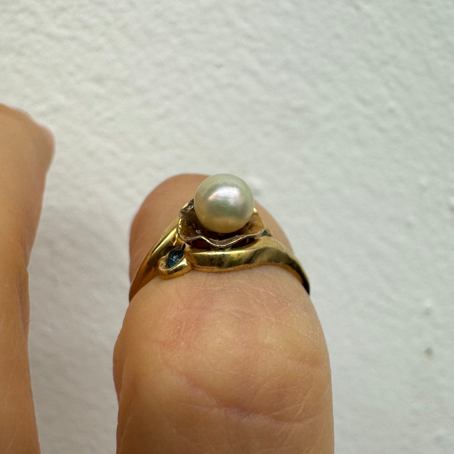 10K yellow gold ring set with a natural Pearl at the center and blue Topaz on the sides.