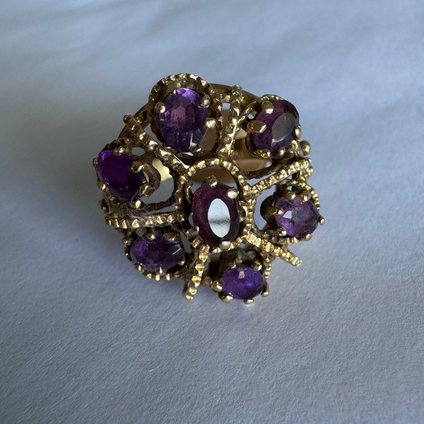 14K yellow gold cocktail ring set with a stunning cluster of Amethyst stones in marquise cuts.
