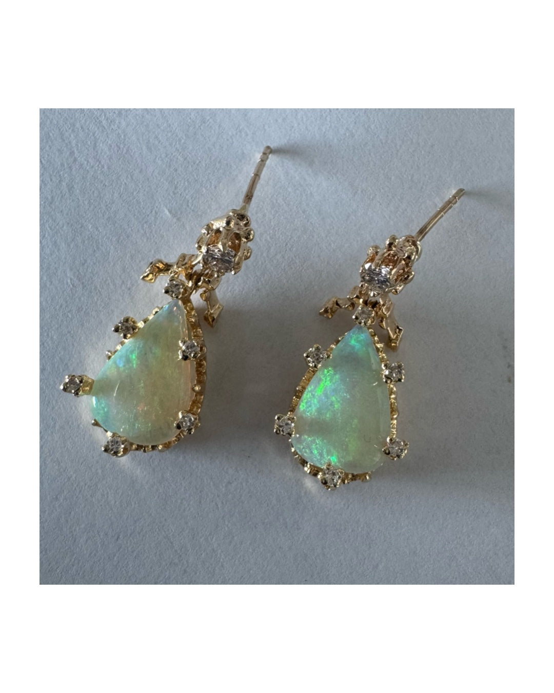 14K gold drop earrings set with pear-shaped Opals and Diamonds.