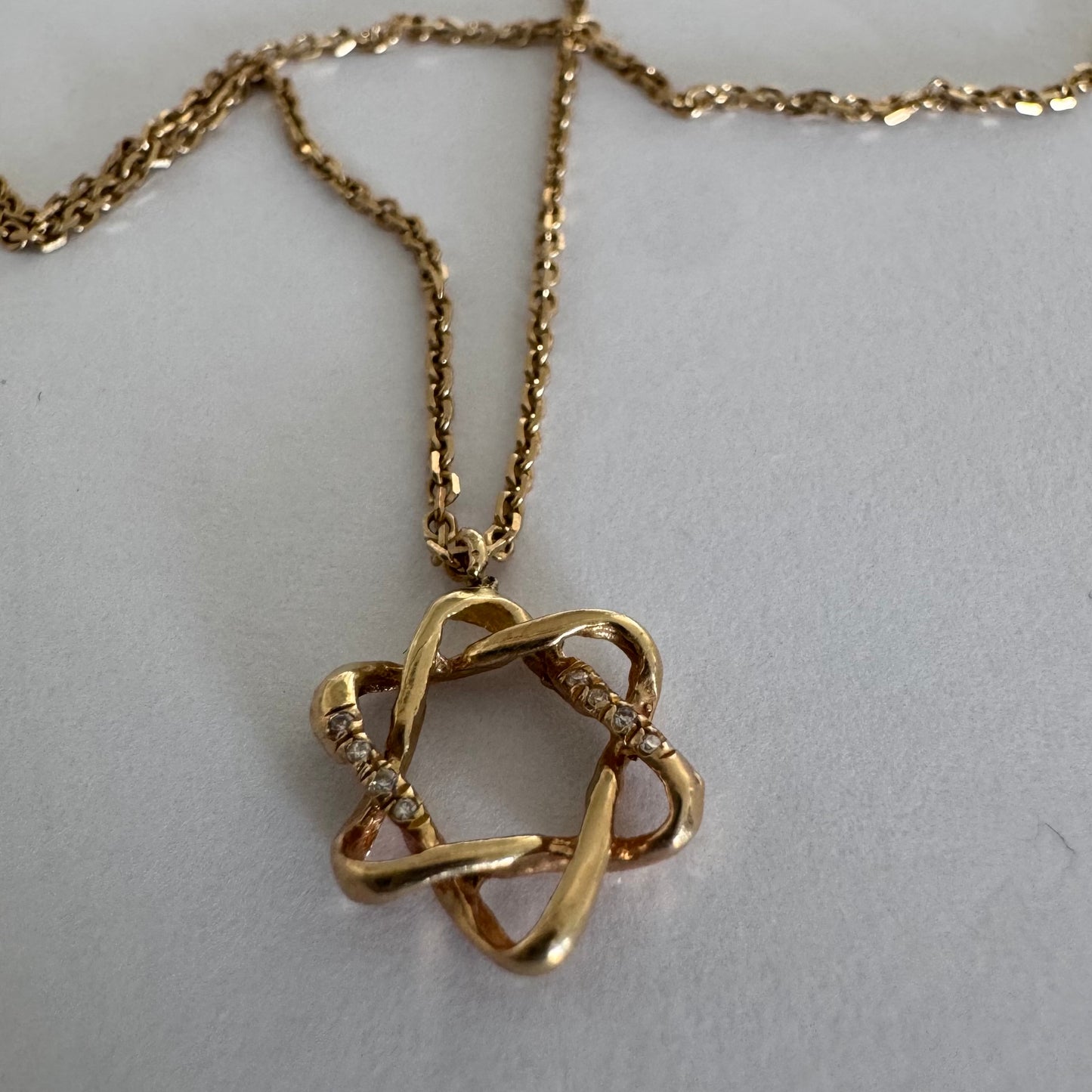 14K gold “Star of David” pendant with a sculptural open design.