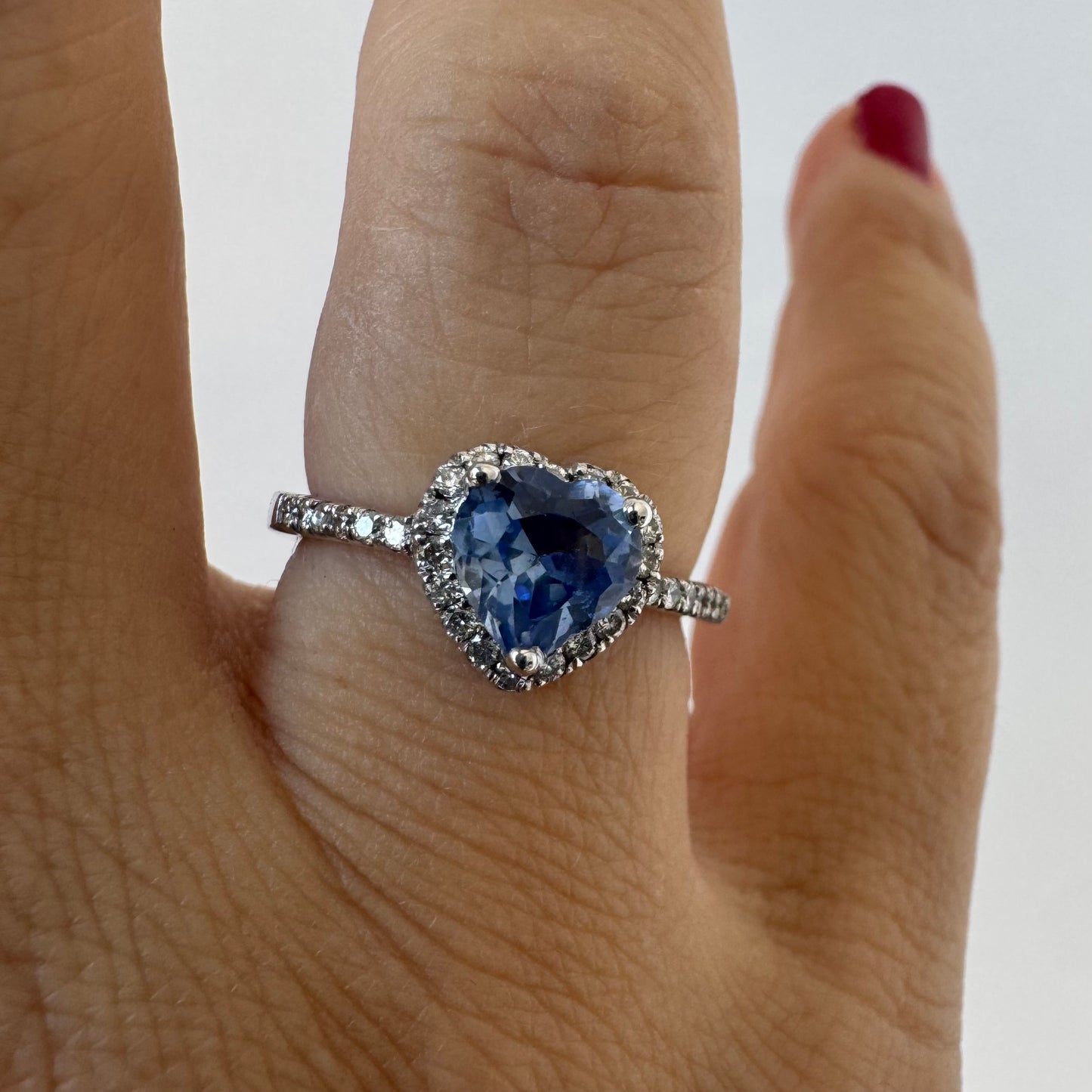 14K gold ring set with a heart-cut Tanzanite surrounded by a halo of Diamonds