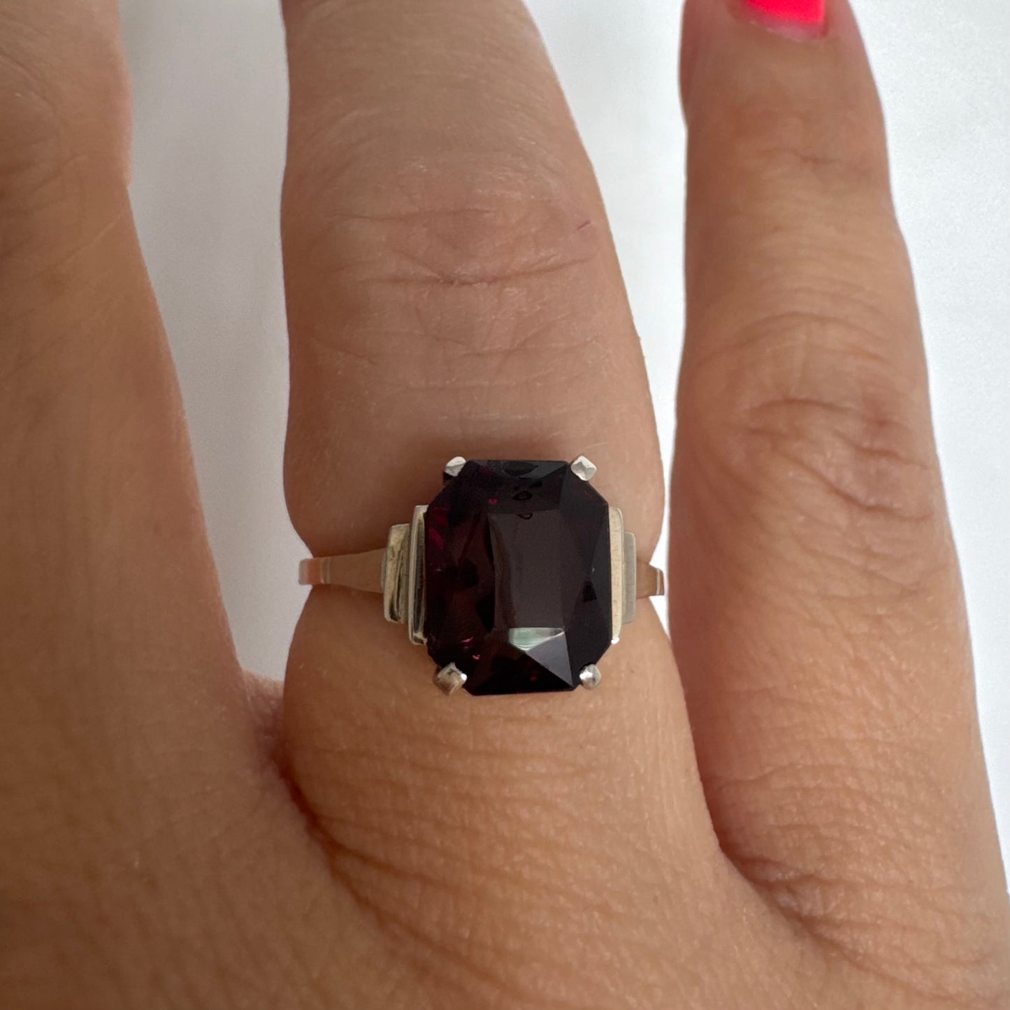 9K gold ring set with a deep burgundy Garnet in an elegant square cut.