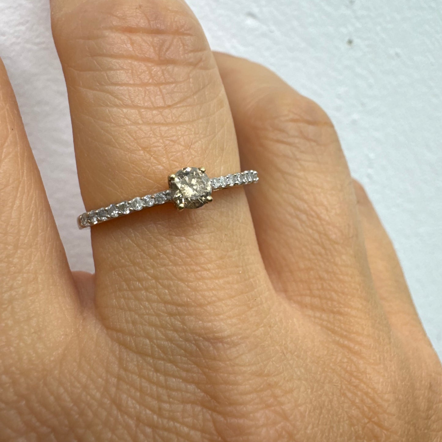 9K gold ring set with a central Diamond and sparkling Diamonds along the band