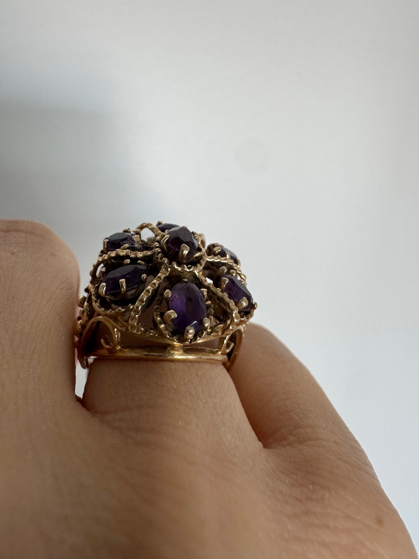 14K yellow gold cocktail ring set with a stunning cluster of Amethyst stones in marquise cuts.