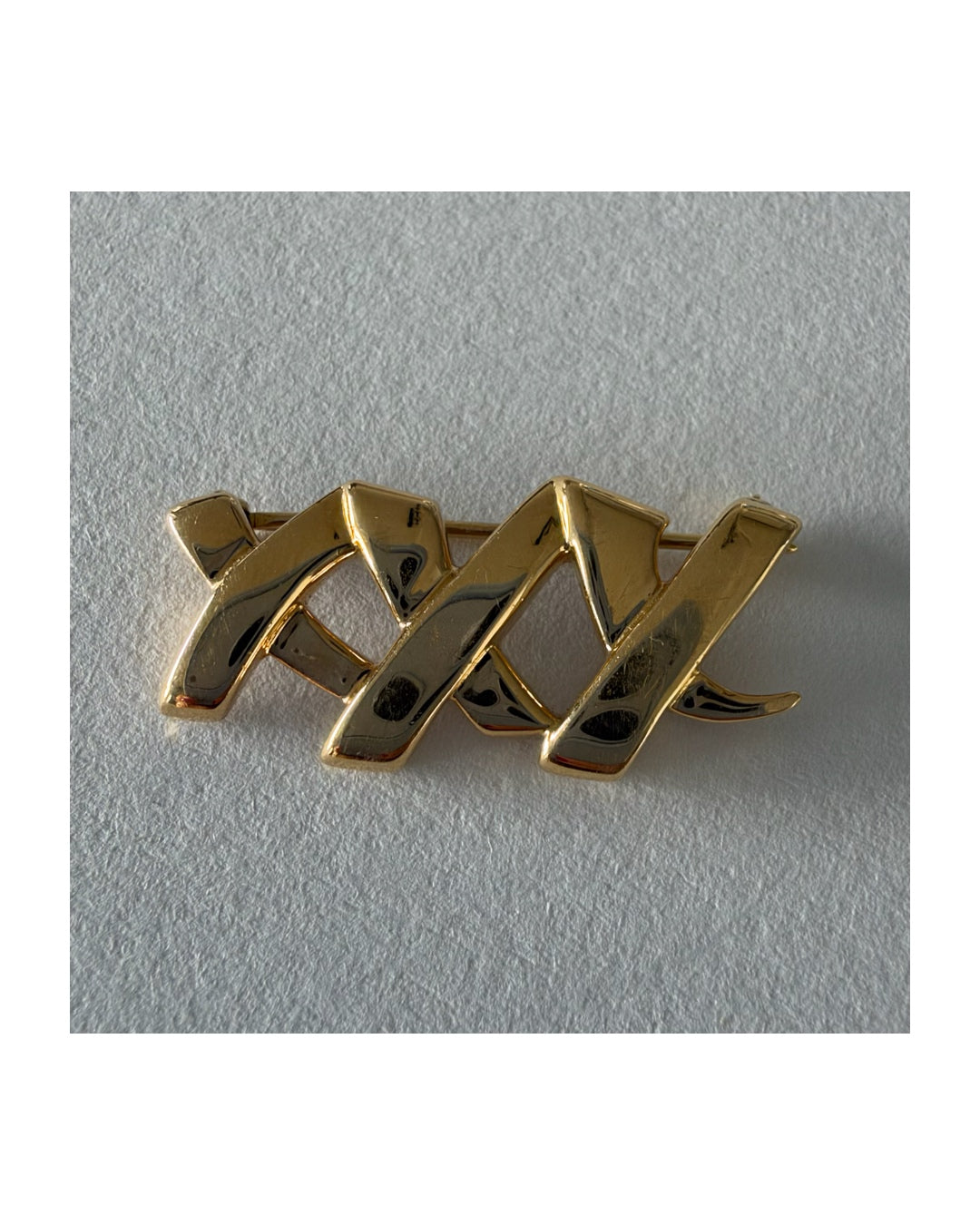 A Tiffany & Co. 18K gold brooch designed by Paloma Picasso from the iconic Graffiti Collection.