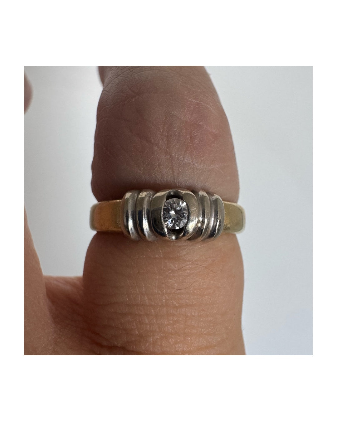 14K two-tone gold ring set with a central Diamond in a clean and refined design