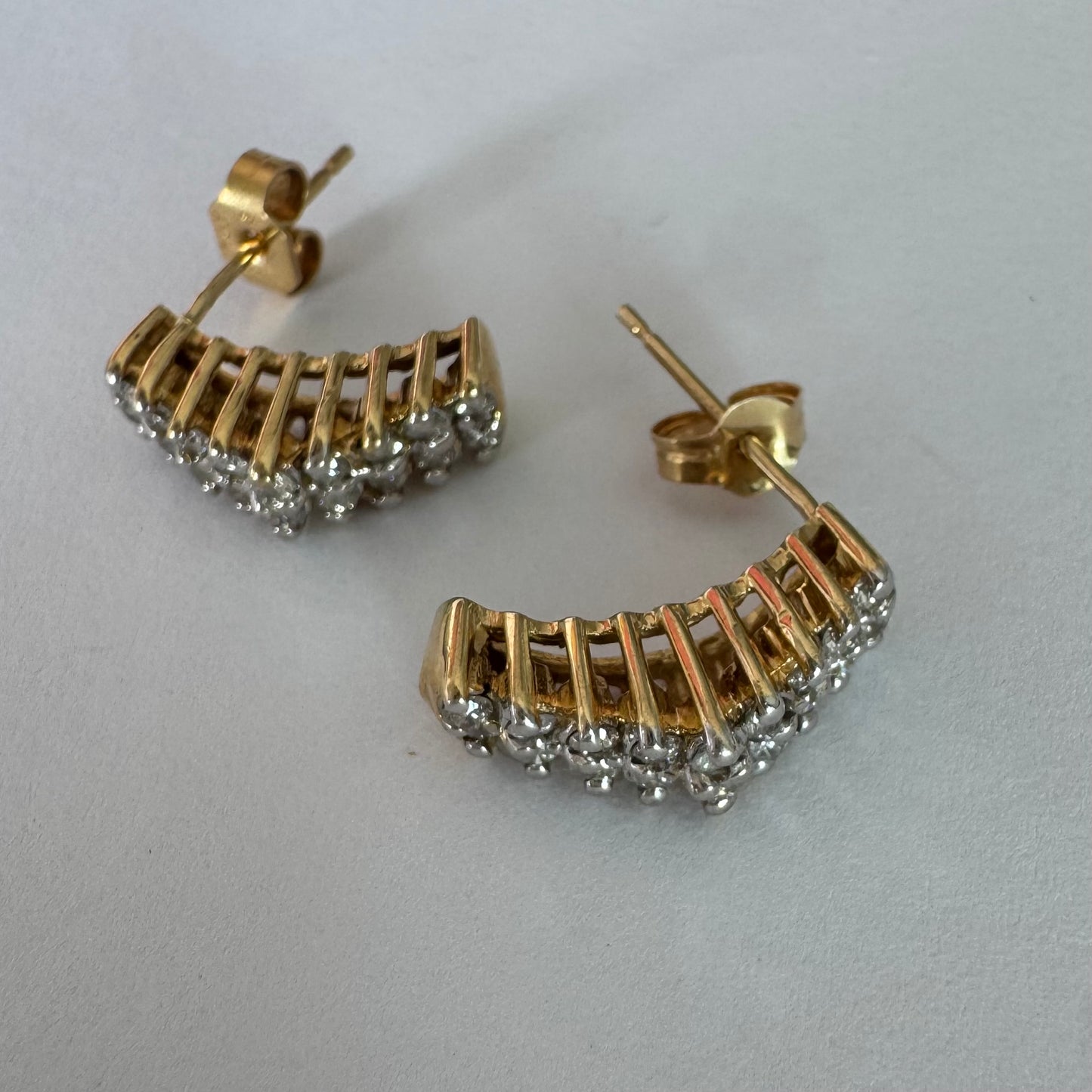 14K gold half-hoop earrings set with sparkling Diamonds in a dense pavé setting