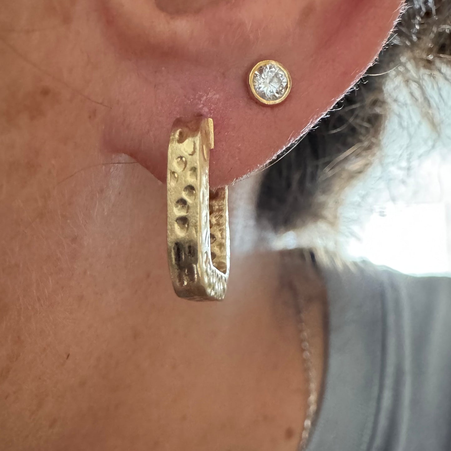 14K gold square hoop earrings with a textured, hammered finish.